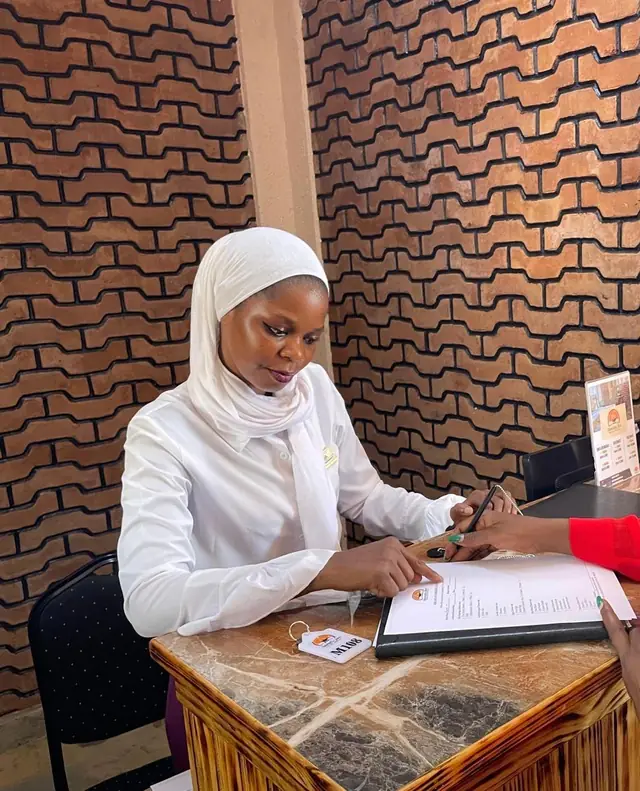 Warm welcome at the Mawimbi Jiko reception desk against the signature wave-patterned brick wall