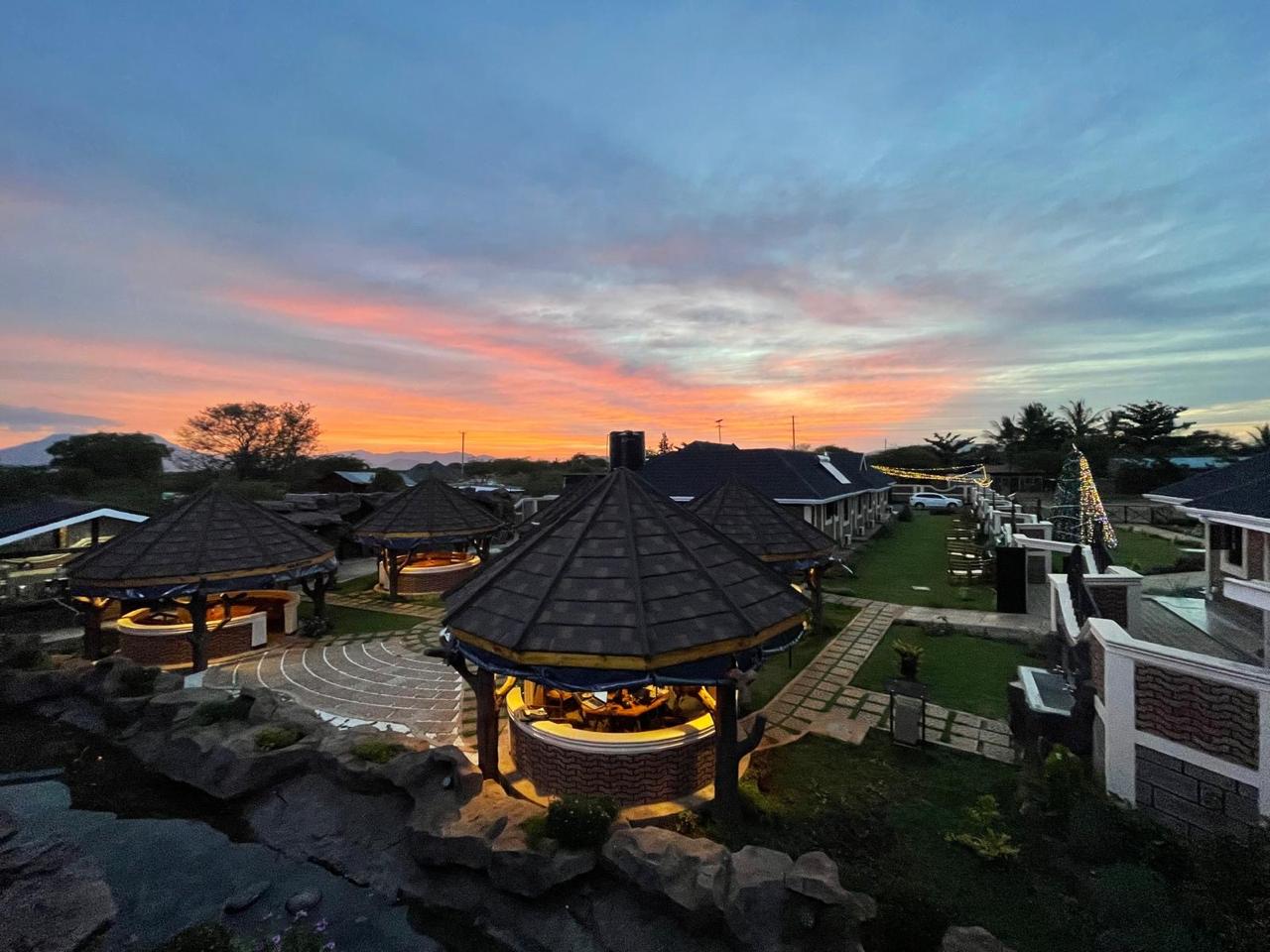 Twilight view across the Mawimbi Jiko gardens, guest wing and festive lighting