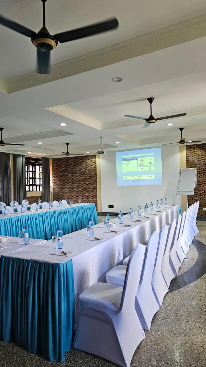 Projector and screen in use during a meeting at the Mawimbi Jiko conference hall