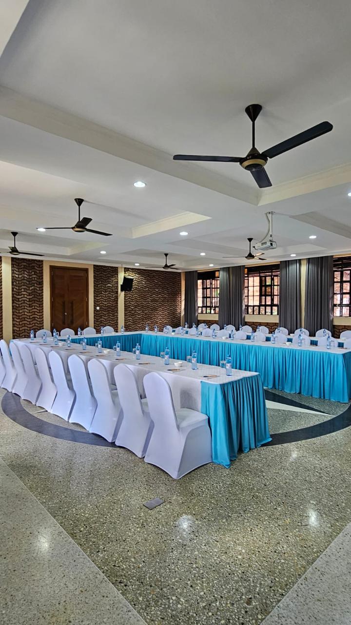 Conference hall seating with ceiling fans, downlights and polished terrazzo floor